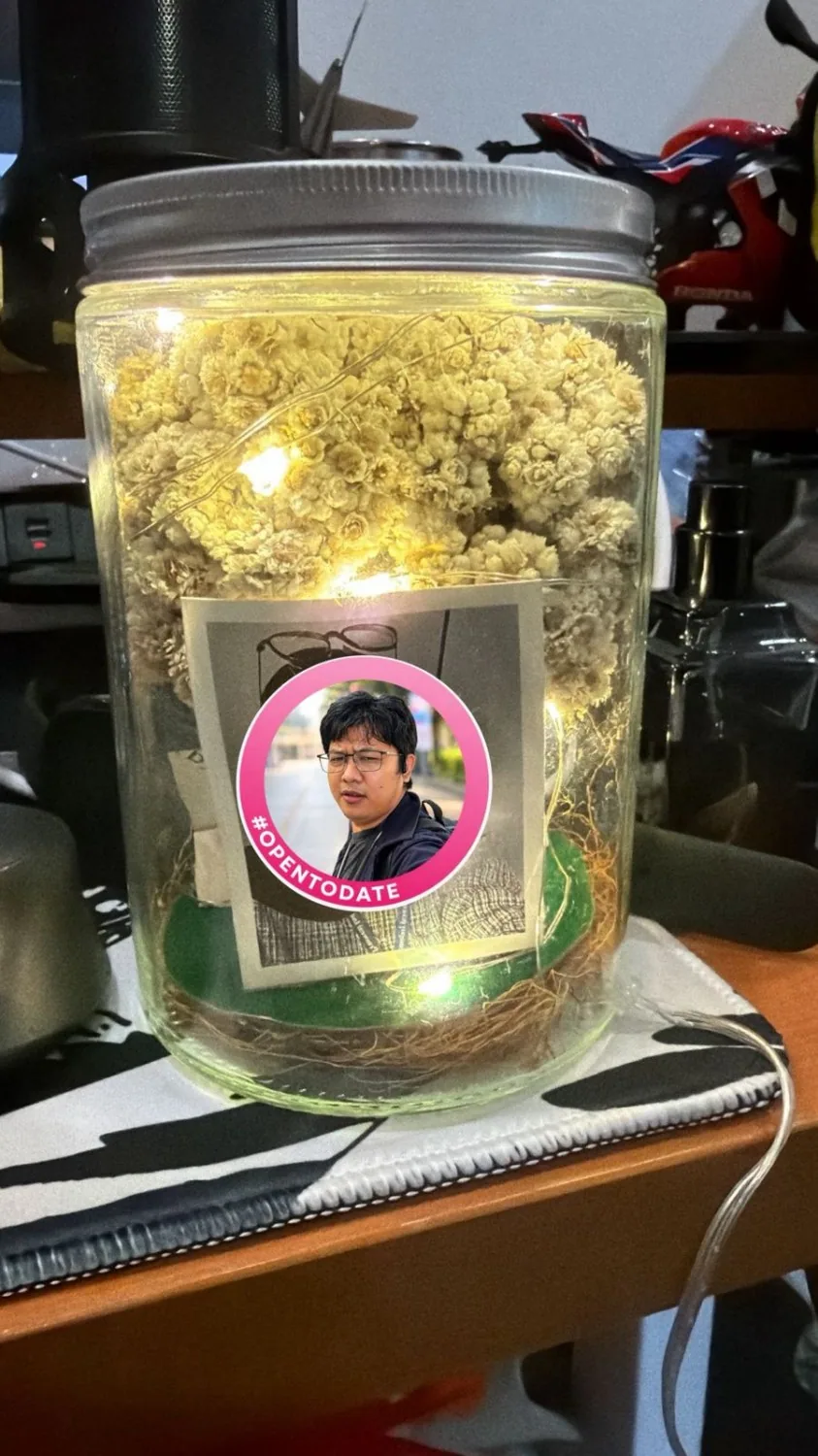 A jar of dried edelweiss with a photo